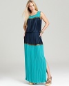 This finely pleated BCBGMAXAZRIA maxi dress boasts rich hues accented with gilded stripes for a hint of shimmer.