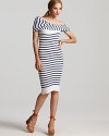 A nautical look with sea-ductive style, this sleek Jean Paul Gaulter dress boasts a twisted off-the-shoulder neckline for an element of allure. Complement the refreshing look with a pop of color and choose vibrant sandals to complete.