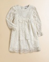 Nothing's lovelier for your little girl than the airy swirls of this lavish lace frock with a flowing skirt and a scalloped hem.Round necklineLong sleeves with ruffled cuffsEmpire waist with bowBack button closeSilk/cotton liningRayon/cotton/nylon/silkDry cleanImported Please note: Number of buttons may vary depending on size ordered. 