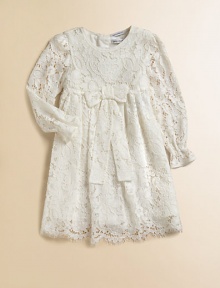 Nothing's lovelier for your little girl than the airy swirls of this lavish lace frock with a flowing skirt and a scalloped hem.Round necklineLong sleeves with ruffled cuffsEmpire waist with bowBack button closeSilk/cotton liningRayon/cotton/nylon/silkDry cleanImported Please note: Number of buttons may vary depending on size ordered. 