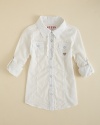 A fitted woven shirt is updated with button tabs at the elbow, ruffle accents and rhinestone accents.