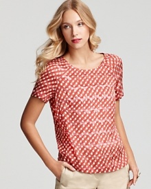 This Tory Burch top is styled in a fresh circle pattern that's chic with anything. Let it peek from beneath a jacket or cardigan, or slip it on with a pair of refined shorts.