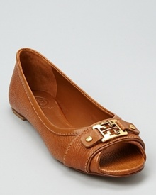 A peep toe flat from Tory Burch--crafted in luxe pebbled leather with shining gold-tone hardware.