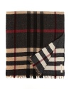 This Burberry plaid scarf is reversible for maximum versatile style. Rich rich, camel and black adorn the front, and the reverse features a faded red, cream and black that hints at vintage cool.