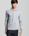 From Burberry, a slim fit longsleeve polo with check accents at the placket lining for a clean, modern look.