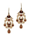 Rich hues add an element of luxury to your ensemble. These elegant Monet earrings feature smoky topaz-colored glass stones surrounded by an intricate gold tone mixed metal setting. Approximate drop: 1-1/2 inches.