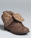 A classic cap toe boot is embellished with distressed leather and knit lining with a foldover upper.