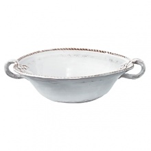 This Vietri serving bowl was crafted by hand in Tuscany of durable, textural terra cotta for an irresistibly warm appeal. Ornament rolls are used to create its ornate designs.