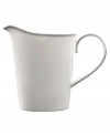 A graceful, classic shape makes this creamer the perfect complement to the Dentelle Covered Sugar Bowl. From innovative designer Monique Lhullier, it features a platinum-edged tiered scallop pattern on creamy white.