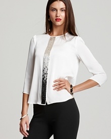 A study in modern design, a cascade of sequins emblazon a boxy VINCE CAMUTO blouse for an effortlessly edgy approach to the classic white shirt.