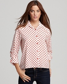 Work spot-on style in an Alice + Olivia polka dot blouse touting playful red buttons though the front and a back box pleat for a polished finish.