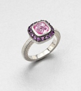 A cushion-cut pink corundum stone surrounded by pavé amethyst stones with a textured sterling silver shank. Pink corundum and amethystSterling silverWidth, about .5Imported 