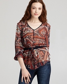 A cinched drawstring waist flatters the frame on this Sam & Lavi tunic, decorated with a lively eclectic print.