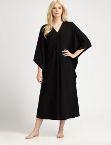 An elegant design with a gathered front and ruffled sides for comfortable, yet sophisticated look. V-neckThree-quarter length kimono sleevesGathered frontRuffled sidesPull-on styleAbout 50 from shoulder to waist67% polyester/33% rayonMachine washImported 