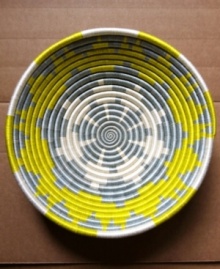 Hope shines among Rwanda's women artisans and in the vivid sun-yellow and slate-blue pattern that distinguishes this handcrafted basket. Filled with fruit or simply accenting a wall, it serves as daily inspiration for women everywhere.