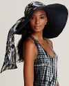 A finely braided floppy hat with a chic multicolored ikat print tie, a must-have for the beach-loving bunch.