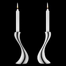 Georg Jensen Cobra candleholders in polished stainless steel. Designed by Constantin Wortmann, who took the familiar silhouette of the traditional candleholder and reinvigorated it with organic curves. It's snakelike strength is shared by its' name.