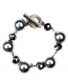 Dressy and decorative. Enhance your workday wardrobe with AK Anne Klein's elegant toggle bracelet. Featuring lustrous imitation gray pearls accented by fashionably faceted beads, it's made in hematite tone mixed metal. Approximate length: 7-1/2 inches.