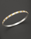 A beautiful bangle from Gurham, crafted with hammered white silver with 24 Kt. yellow gold stud accents.