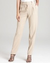 Delicate pleats lend feminine dimension to these T Tahari pants, finished in a neutral shade for a summer-fresh approach to office wear. Style with a crisp white blouse for effortless elegance.