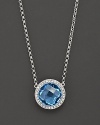 Blend some cool blues into your look. This stunning blue topaz pendant necklace features gleaming diamond accents on 14 Kt. white gold.