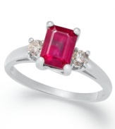 A cut above the rest. This stunning three-stone ring highlights an emerald-cut ruby (1-1/5 ct. t.w.) highlighted on either side by a round-cut diamond (1/5 ct. t.w.). Set in 14k white gold.