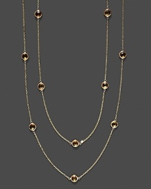 Eighteen faceted citrine stations sparkle in a long, loopable 14K yellow gold chain.