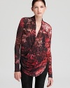 A fiery print adorns this wrap-style Helmut Lang tunic with high-low hemline and flattering draping.