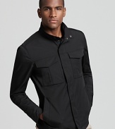 Streamlined and modern, a black waist-length zip up jacket from Theory adds instant style to transitional weather attire.