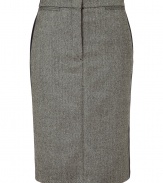 Luxurious skirt in a fine wool and cashmere blend - Features a classic herringbone pattern in black and ecru - Slim, narrow pencil cut with decorative side stripes and small welt pockets with button closure at back - Sophisticated look with a blazer, blouse and heels - Transitions effortlessly from office to evening