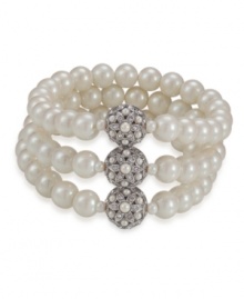 Add vintage glamour to an everyday look with this romantic bracelet by Carolee. Three rows of glass pearls secured by three medallions gleaming with crystal accents. Crafted in imitation rhodium-plated mixed metal. Stretches to fist wrist. Approximate diameter: 3-1/4 inches.