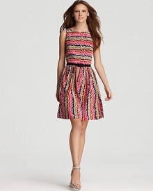 A colorful zigzag print brightens up this Trina Turk day dress, cinched with a black grosgrain belt and featuring a demure pleated skirt.