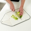 The patented Rinse & Chop Joseph Joseph chopping board folds to create a strainer at one end, and a chute at the other. Fold and lock the board into position to rinse; open and flatten to chop, then fold again to pour food easily into a pan.