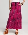 Strike out in this bold floor-skimming maxi skirt by C&C California. A vibrant boost of color revs up this updated tie-dye print for 21st century style.