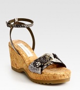 Practical rubber sole provides traction for this natural cork wedge with adjustable faux leather snake-print straps. Cork wedge, 3 (75mm)Cork platform, 1 (25mm)Compares to a 2 heel (50mm)Snake-print faux leather upperCork liningRubber solePadded insoleImportedOUR FIT MODEL RECOMMENDS ordering one half size up as this style runs small. 