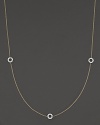 A delicate yellow gold chain with three double-sided white gold diamond circle stations.