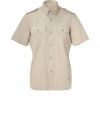 This military-inspired button down brings spring-ready ease to your casual ensembles - Small spread collar, epaulets, short sleeves, two flap chest pockets, asymmetrical curved hem, back pleat detail - Wear with straight leg jeans or chinos and trainers