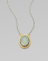 From the Gauntlet Collection. A smooth oval of pastel aqua chalcedony is elegantly framed in granulated sterling silver and hammered 24k gold, on a silver chain.Aqua chalcedonySterling silver and 24k yellow goldChain length, about 18Pendant length, about ¾Imported