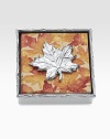 A cast maple leaf holds down a set of leaf-print napkins in a matching aluminum holder. Handmade Caspari napkins included 1½H X 5¾W X 5¾D Wipe clean Imported