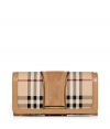 With its characteristic check and modern metallic piping, Burberry Londons continental wallet is an iconic way to keep your most valuable essentials organized - Haymarket check coated canvas, trench suede panel, matching leather trim, flap with snap closure, back slot pocket, multiple credit card slots inside, zippered coin purse - Carry alone for running quick errands, or stash away in a sophisticated leather tote