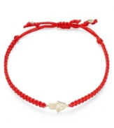 A stylish good luck symbol. This trendy wrap bracelet features a 14k gold hamsa charm strung from a red nylon rope cord. Approximate diameter: 2-1/4 inches (extends to 3-1/2 inches).