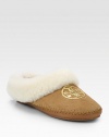 Light-catching sequins form a signature medallion on this casual suede staple lined with cozy shearling. Suede and shearling upper with sequinsShearling liningRubber solePadded insoleImported