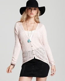 An easy pink Free People cardigan softens directional fall pieces with a sheer, loose knit and chic asymmetric hem.