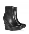 An edgy, sculptural wedge heel informs these ultra-versatile leather wedge booties from Diane von Furstenberg - Round toe, front platform, layered wedge heel, ankle length, side zip closure, textured leather - Pair with skinny jeans and an oversized pullover or with a printed mini-dress and ribbed tights