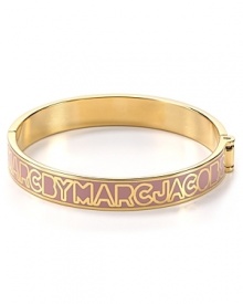 MARC BY MARC JACOBS lends it's signature stamp to this 12-karat gold plated bangle. Slip this piece on your wrist to give your bracelet stack a branded touch.