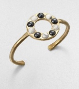 From the Cabochon Collection. A slender yet bold cuff is dotted with a circle of cabochon stones, some with a gunmetal finish, some with natural veining, all adding impact to this sophisticated design.Natural stone18k goldplatedDiameter, about 2.25Made in USA