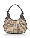 Printed PVC hobo with leather trim and single shoulder strap. Goldtone hardware and pleated accents. Top zip closure. Interior zip, cell phone, and additional pockets. Lined.