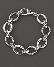 Smooth and fluted link sterling silver bracelet, with a logo lobster clasp. Designed by Lagos.