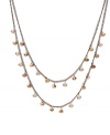 Light up your look with this luxe design. Kenneth Cole New York necklace highlights dangling bronze-colored  beads strung from two tiers of chains. Crafted in gold tone mixed metal. Approximate length: 15-3/4 inches + 3-inch extender. Approximate drop: 3-1/2 inches.