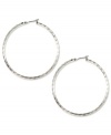 No accessory wardrobe is complete without a fabulous pair of hoop earrings, like these silver tone stunners from Anne Klein. The textured detailing adds an instant update to a classic look. Crafted in imitation rhodium mixed metal. Approximate diameter: 2 inches.